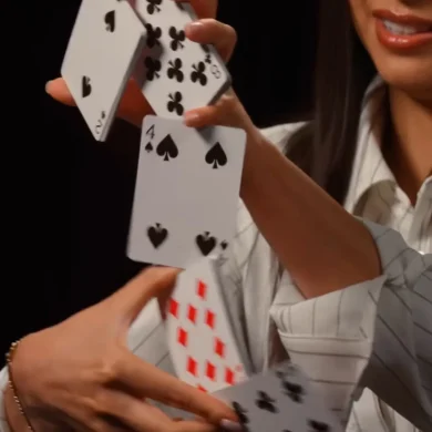 Anna DeGuzman performing a card cascade and sleight of hand with playing cards